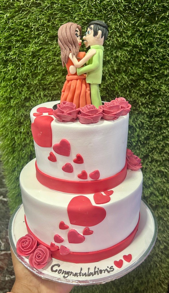 A beautiful custom two-tier cake with a couple figurine